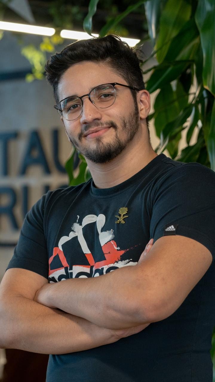 Ilyes at the office, arms crossed